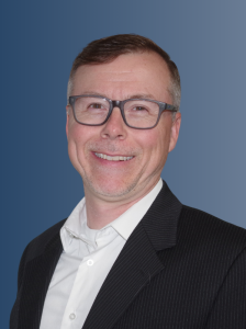 Professional headshot of Nolen Akerman, a data science leader and member of the Our Experts team at Demand Chain AI Inc.