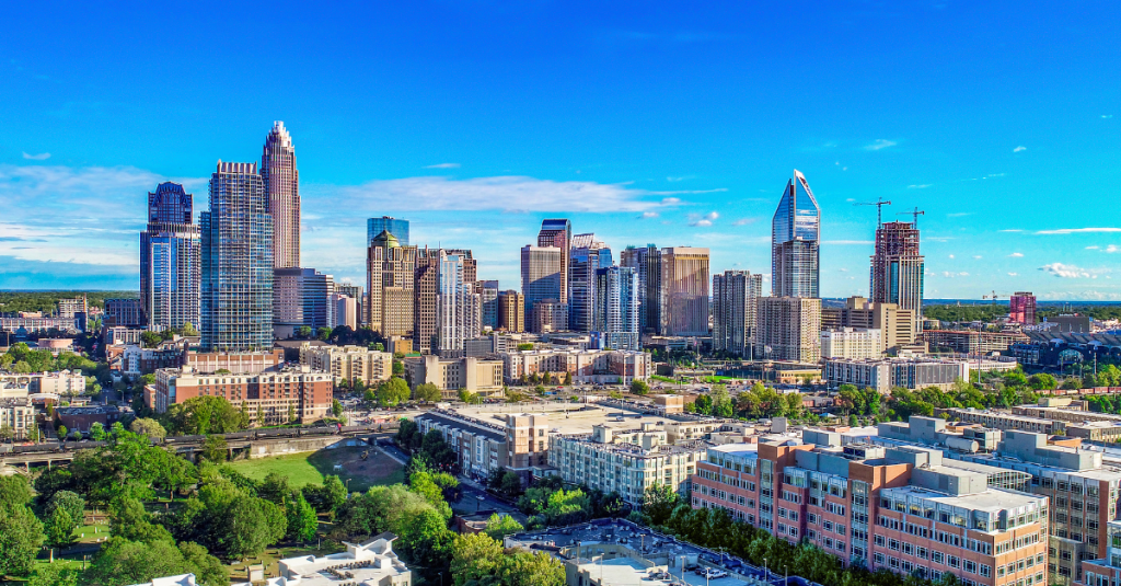 Aerial view of Charlotte’s urban skyline, with tall buildings and modern development near the CSCMP NC Supply Chain Technology Conference.